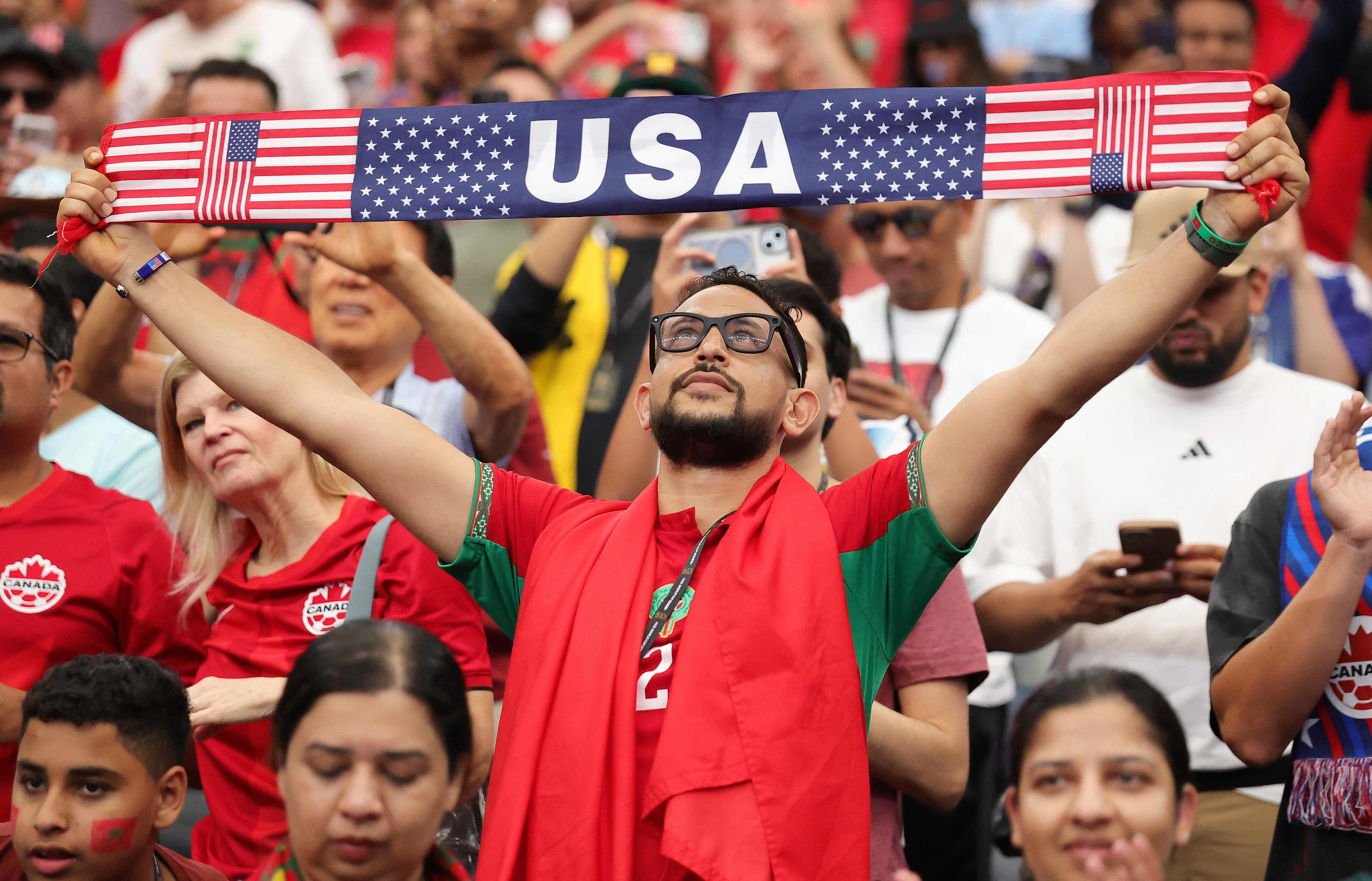 HOUSTON, TEXAS - JULY 04: A fan holds a United States banner in the stands during the FIFA World Cup 2026 Round of 16 match between Canada and Morocco at Houston Stadium on July 04, 2026 in Houston, Texas.   Alex Slitz/Getty Images/AFP (Photo by Alex Slitz / GETTY IMAGES NORTH AMERICA / Getty Images via AFP)