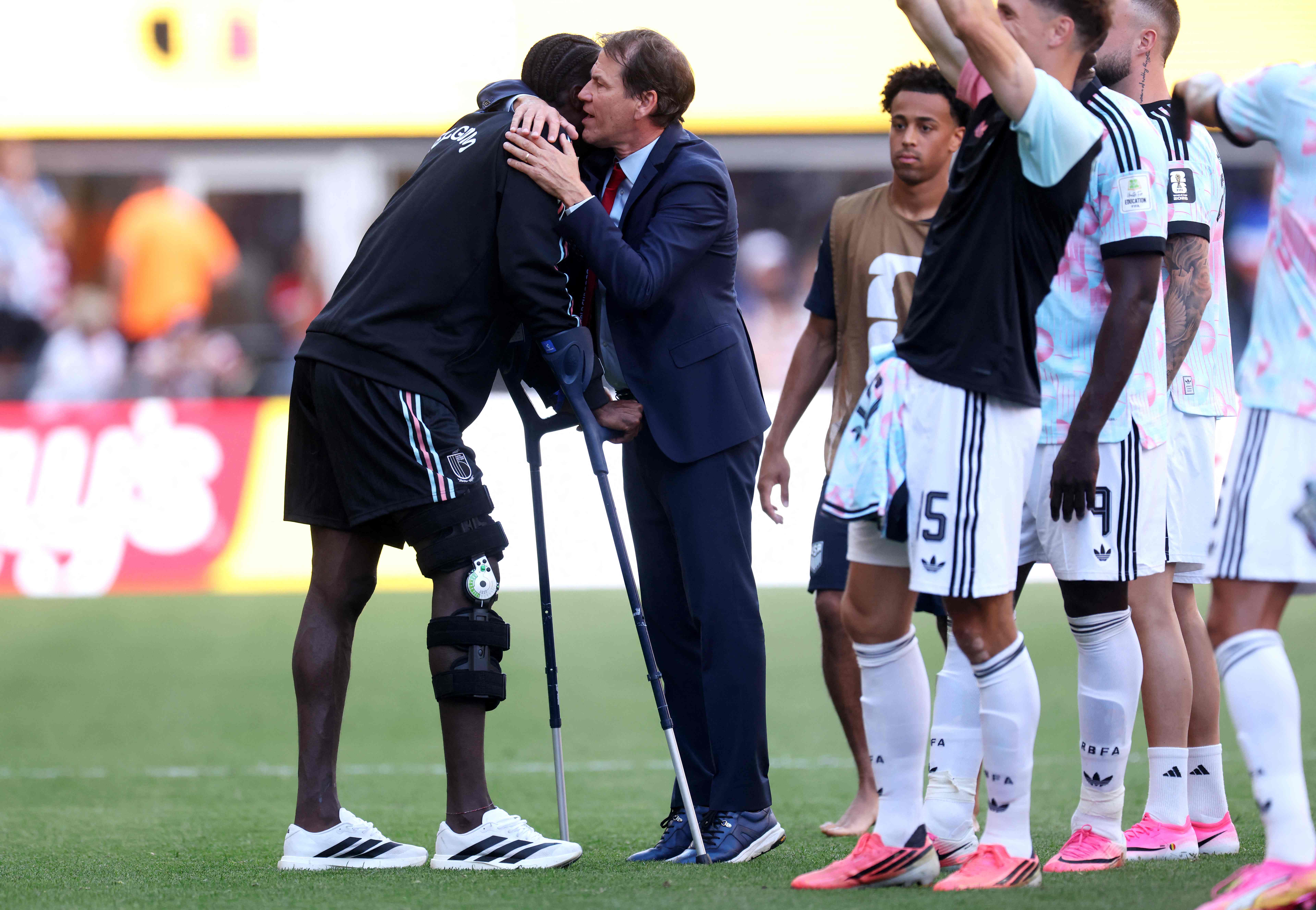 SEATTLE, WASHINGTON - JULY 06: Rudi Garcia, Head Coach of Belgium, embraces Amadou Onana #24 after the 4-1 victory during the FIFA World Cup 2026 Round of 16 match between USA and Belgium at Seattle Stadium on July 06, 2026 in Seattle, Washington.   Jamie Squire/Getty Images/AFP (Photo by JAMIE SQUIRE / GETTY IMAGES NORTH AMERICA / Getty Images via AFP)