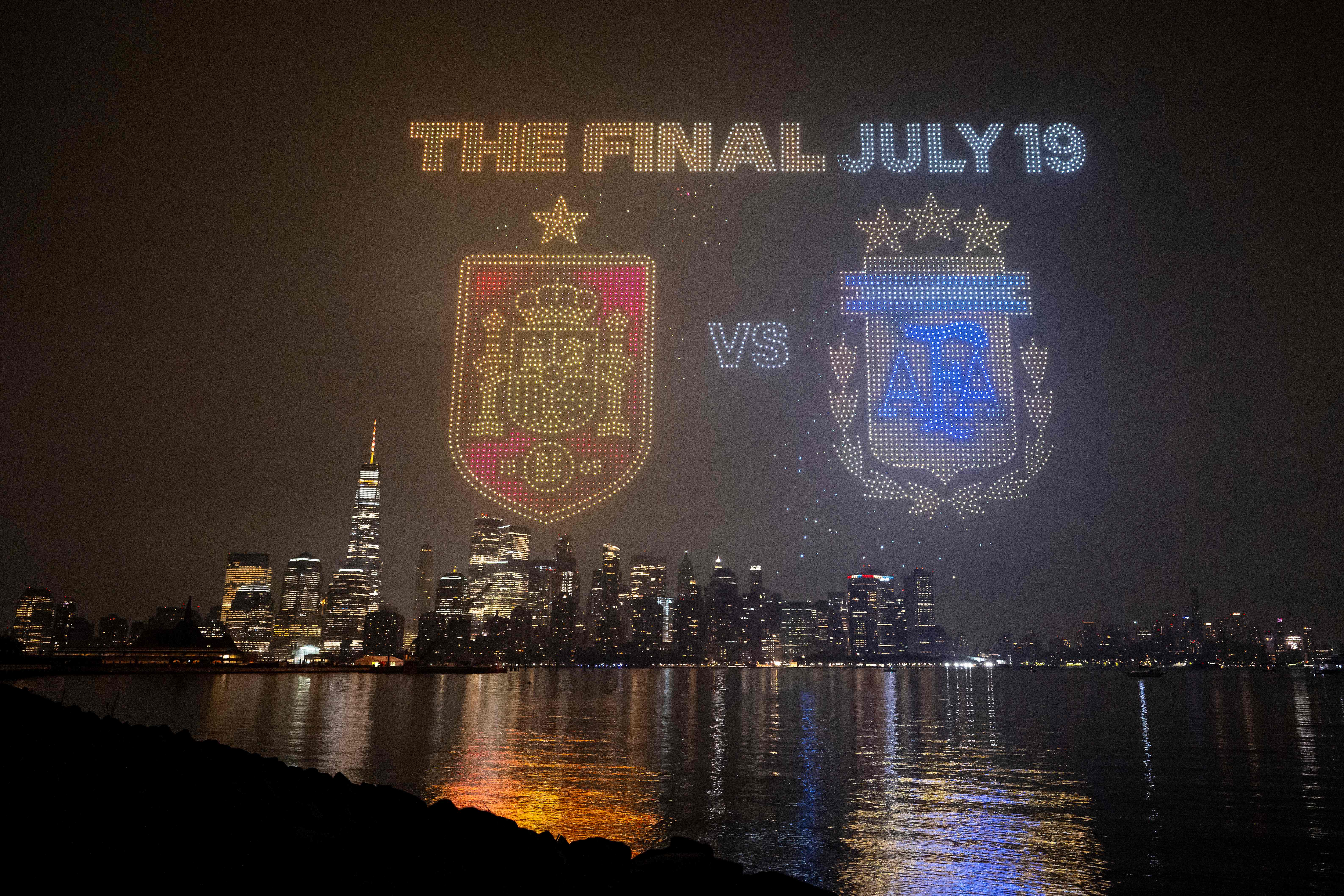 JERSEY CITY, NEW JERSEY - JULY 15: The Final July 19 visual with the crests of Spain and Argentina is displayed against the Manhattan skyline during the FIFA Drone show in New York/New Jersey at Liberty State Park on July 15, 2026 in Jersey City, New Jersey. David Ramos/Getty Images/AFP (Photo by David Ramos / GETTY IMAGES NORTH AMERICA / Getty Images via AFP)