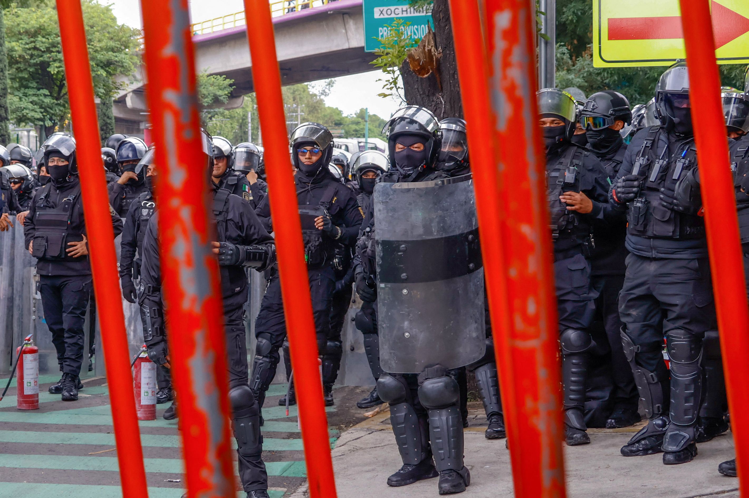 Members of the police block the way to the Ciudad de Mexico Stadium during a protest in Mexico City on June 9, 2026. Thousands of teachers blocked an avenue leading to the Azteca Stadium in Mexico City, 48 hours before the opening ceremony of the 2026 World Cup at that venue. (Photo by Gerardo Magallon / AFP)