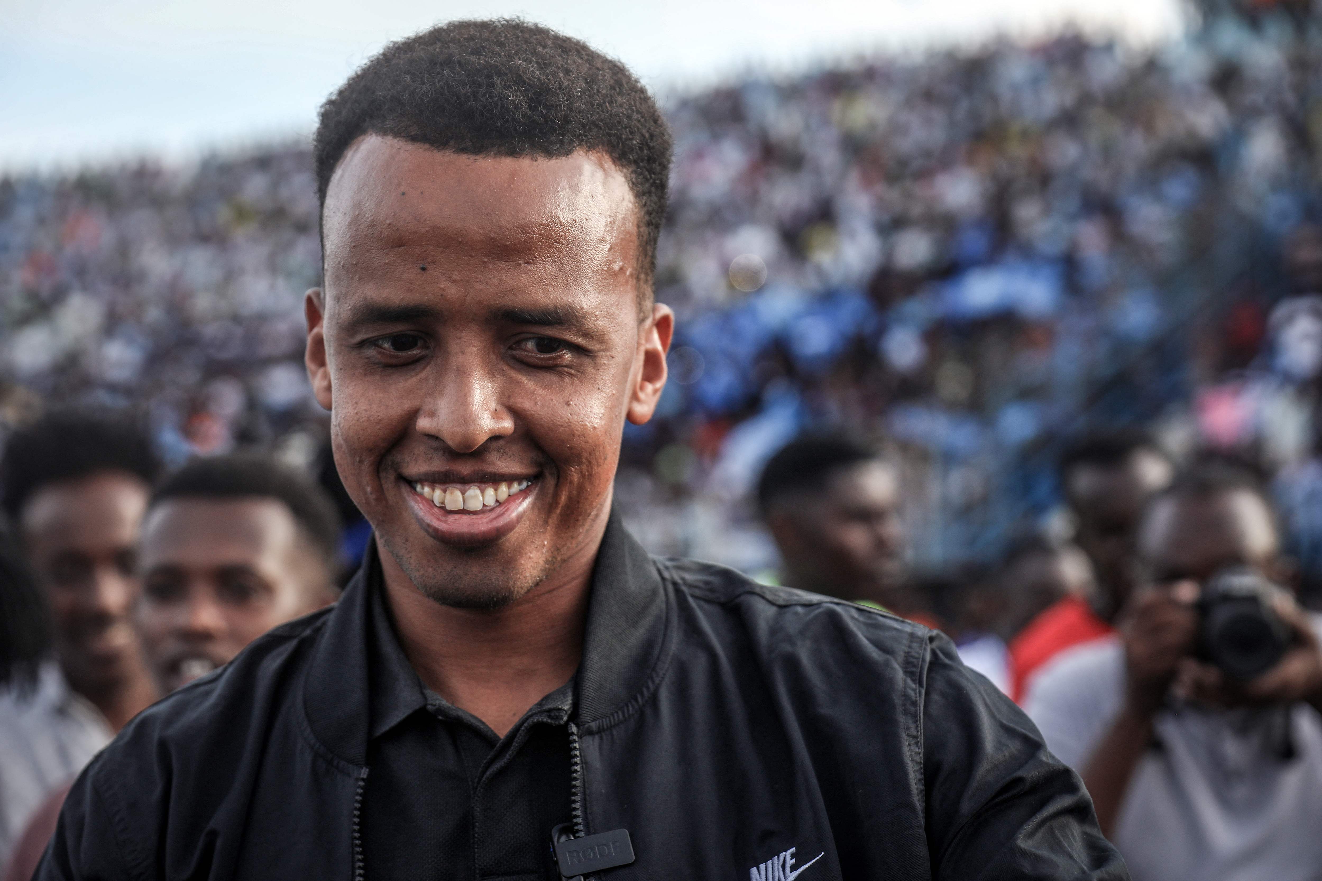 Somali international referee Omar Abdulkadir Artan reacts as he is welcomed by supporters ahead of a solidarity football match after returning to Somalia in Mogadishu on June 10, 2026. Somali referee Omar Artan, who was denied entry to the United States for the World Cup, returned to a hero's welcome in Mogadishu and vowed to take part in the next tournament in 2030. Artan's rejection has sparked outrage at home.Artan, who in 2025 was named men's referee of the year by the Confederation of African Football (CAF), was barred from entering the US on Saturday after arriving at Miami International Airport. (Photo by Hassan Ali Elmi / AFP)