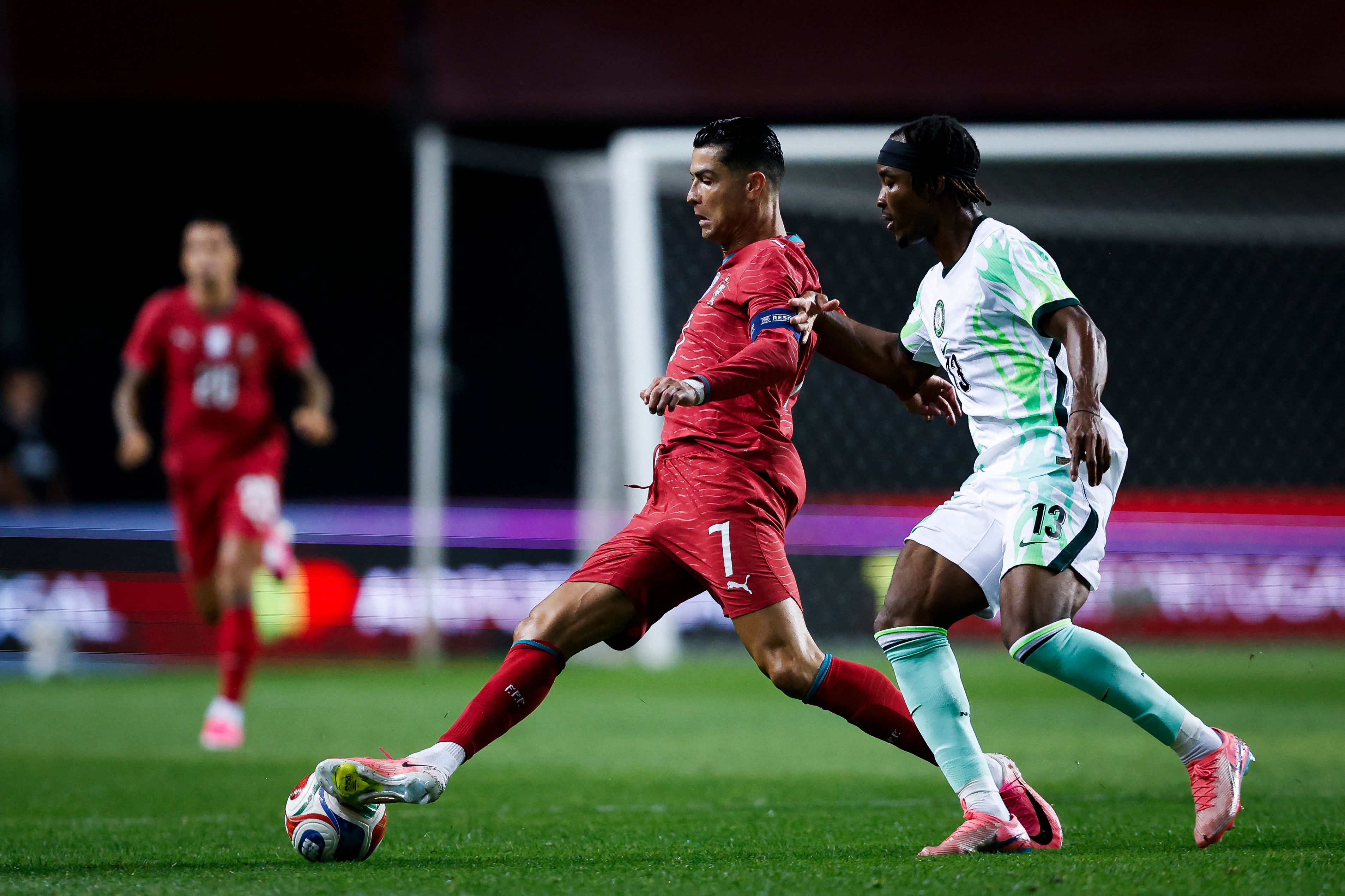 Portugal's forward #07 Cristiano Ronaldo fights for the ball with Nigeria's defender #13 Bruno Onyemaechi during the international friendly football match between Portugal and Nigeria at Magalhaes Pessoa Stadium in Leiria, on June 10, 2026. (Photo by FILIPE AMORIM / AFP)