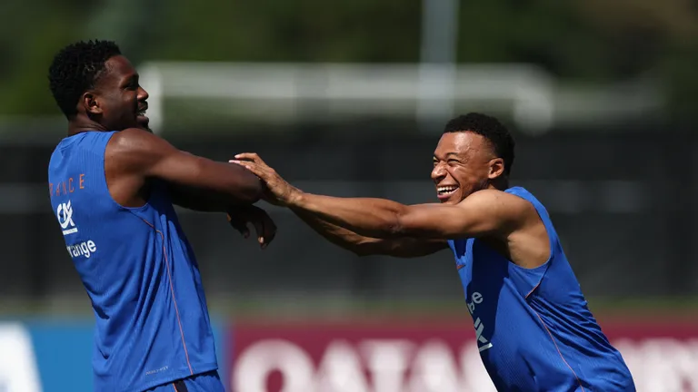 France's forward #10 Kylian Mbappe (R) jokes with France's forward #09 Marcus Thuram during training session at Bentley University, the team's base camp, as part of the 2026 World Cup football tournament in Waltham, near Boston, on June 12, 2026. (Photo by FRANCK FIFE / AFP)
