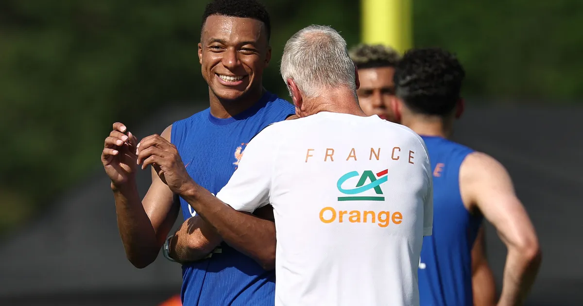France's head coach Didier Deschamps (R) and France's forward #10 Kylian Mbappe react as they take part in a training session at Bentley University, the team's base camp, during the 2026 World Cup football tournament in Waltham, near Boston, on June 12, 2026. (Photo by FRANCK FIFE / AFP)