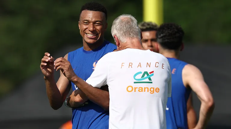 France's head coach Didier Deschamps (R) and France's forward #10 Kylian Mbappe react as they take part in a training session at Bentley University, the team's base camp, during the 2026 World Cup football tournament in Waltham, near Boston, on June 12, 2026. (Photo by FRANCK FIFE / AFP)