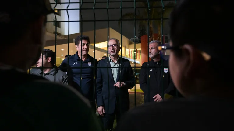 Iran's ambassador to Mexico Abolfazl Pasandideh (C) and Football Federation of Iran (FFIRI) secretary general Hedayat Mombeini (2nd L) speak to supporters and media representatives after Iran's elimination from the 2026 FIFA World Cup football tournament at the Marriott Hotel in Tijuana, Mexico, on June 27, 2026. (Photo by Guillermo Arias / AFP)