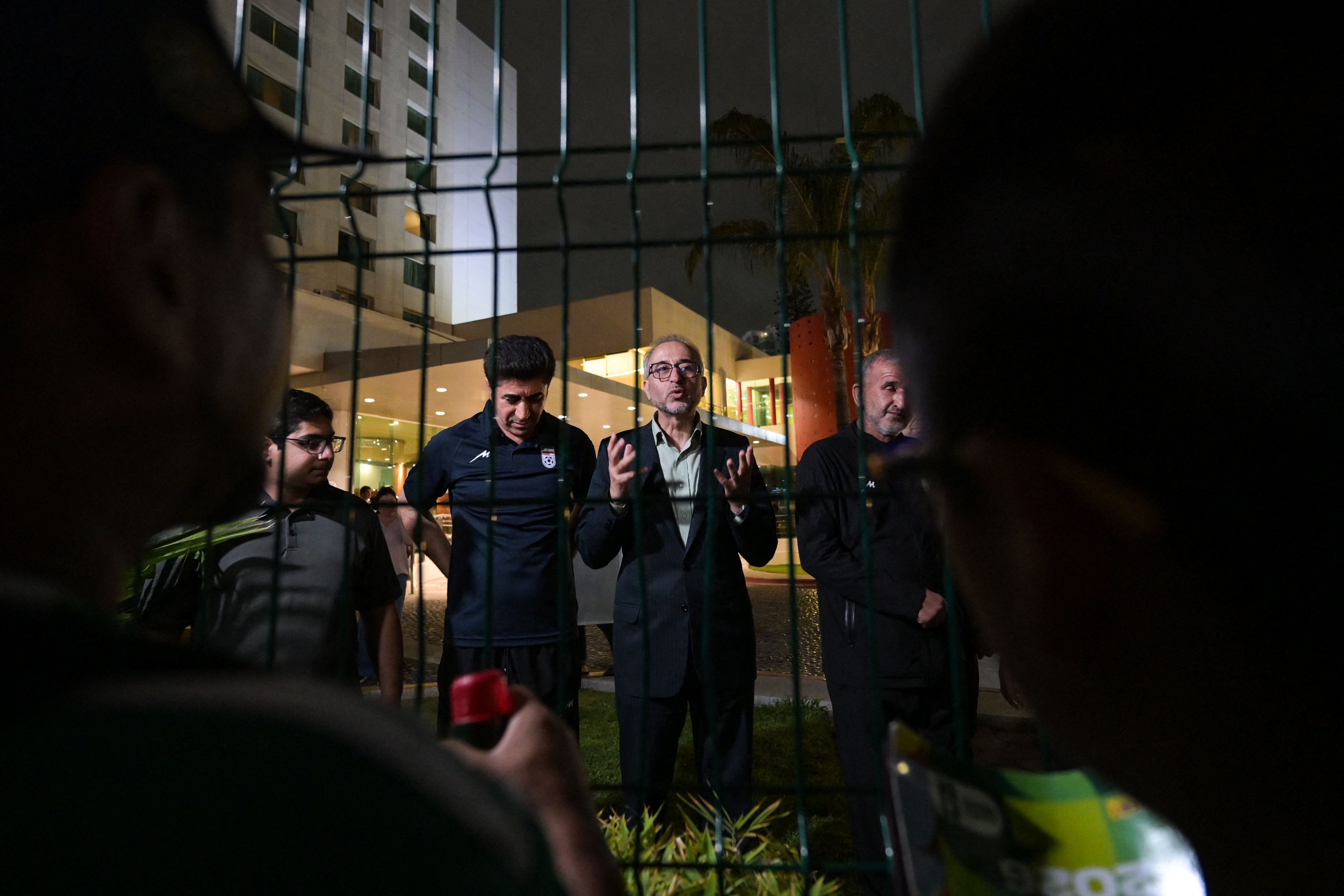 Iran's ambassador to Mexico Abolfazl Pasandideh (C) and Football Federation of Iran (FFIRI) secretary general Hedayat Mombeini (2nd L) speak to supporters and media representatives after Iran's elimination from the 2026 FIFA World Cup football tournament at the Marriott Hotel in Tijuana, Mexico, on June 27, 2026. (Photo by Guillermo Arias / AFP)
