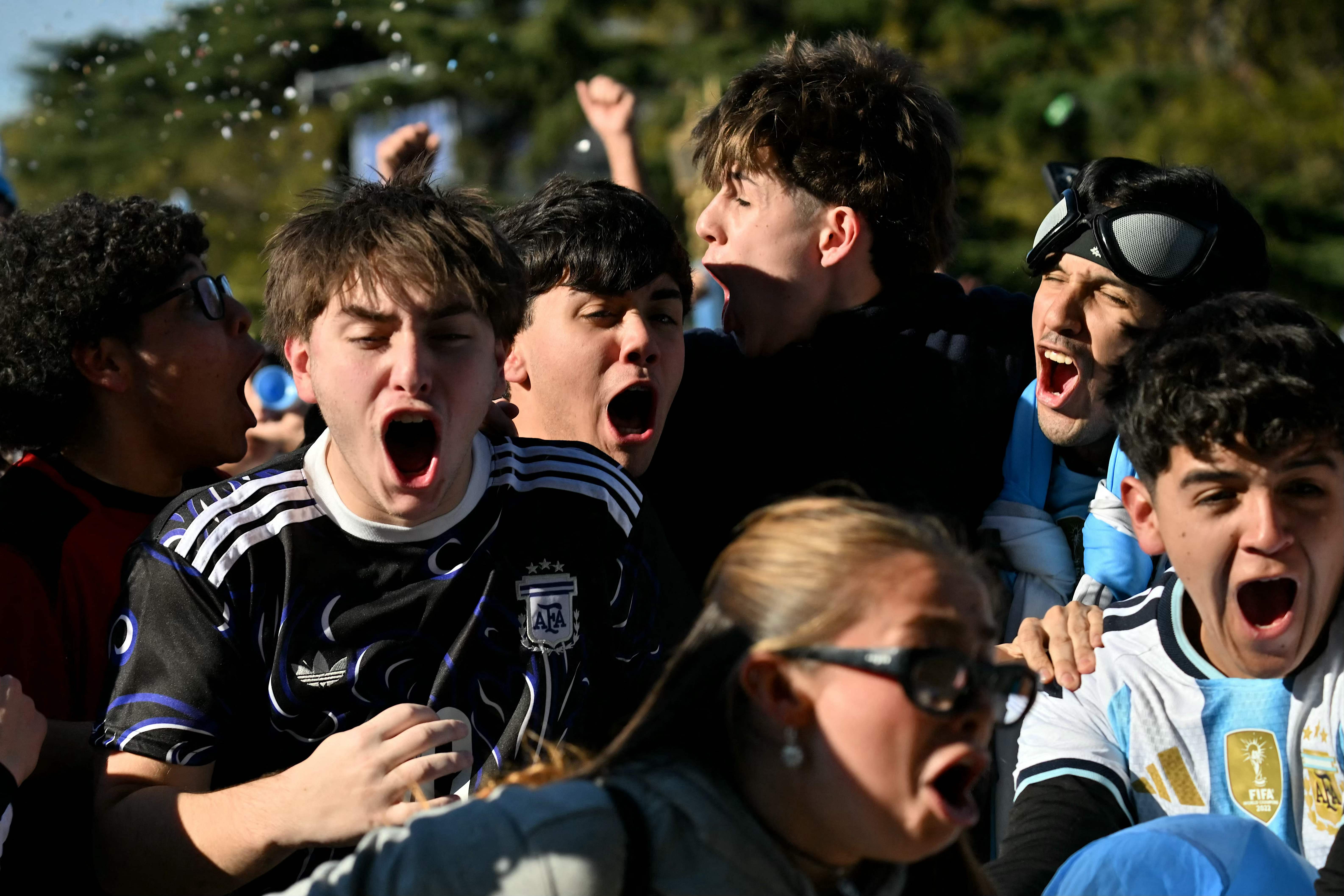 Fans of Argentina react as they watch the FIFA World Cup 2026 round-of-16 football match between Argentina and Egypt on a giant screen in Buenos Aires on July 7, 2026. (Photo by Luis ROBAYO / AFP)
