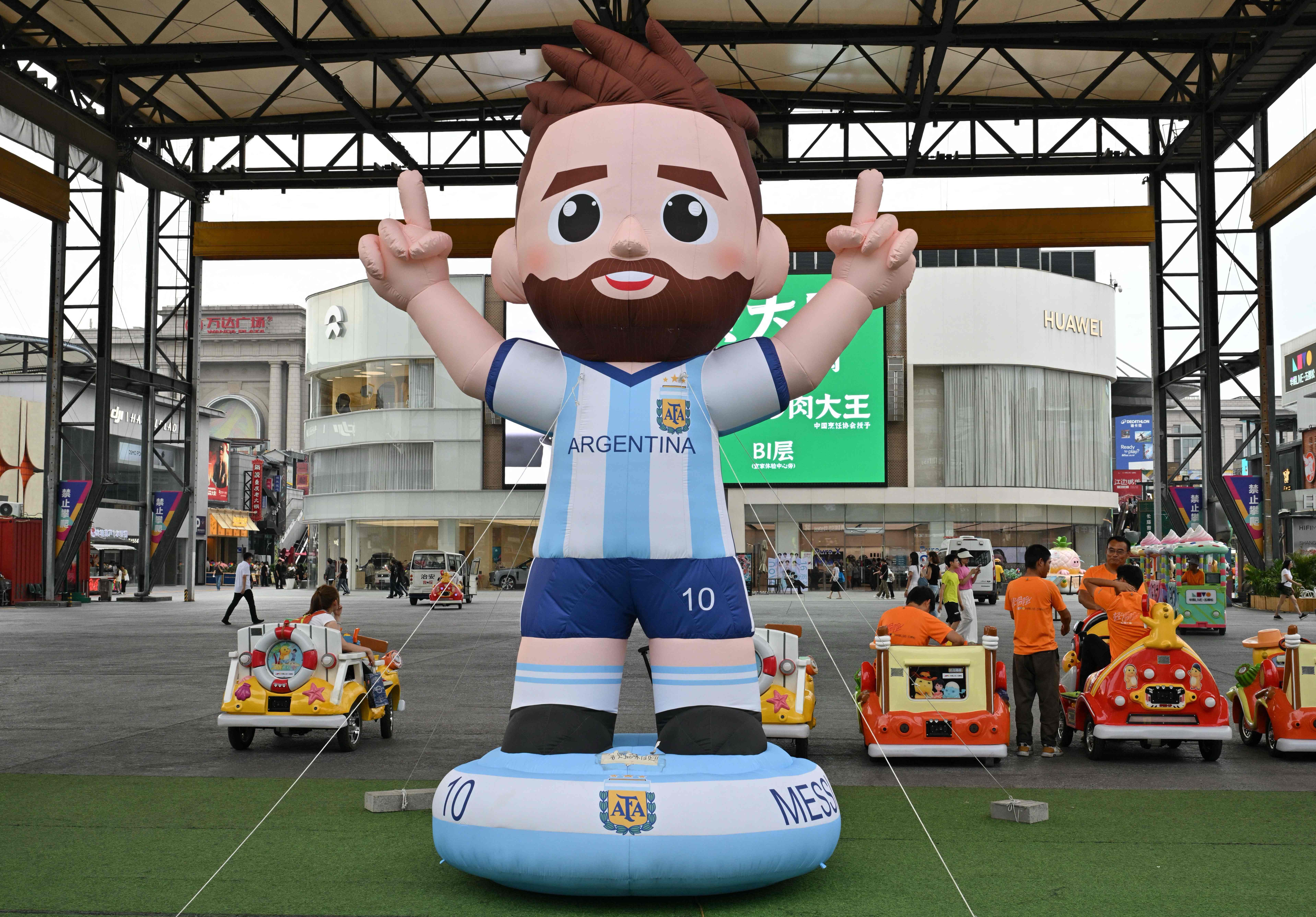 An inflatable statue of Argentina's football player Lionel Messi is pictured at a shopping mall in Beijing on July 9, 2026. (Photo by ADEK BERRY / AFP)
