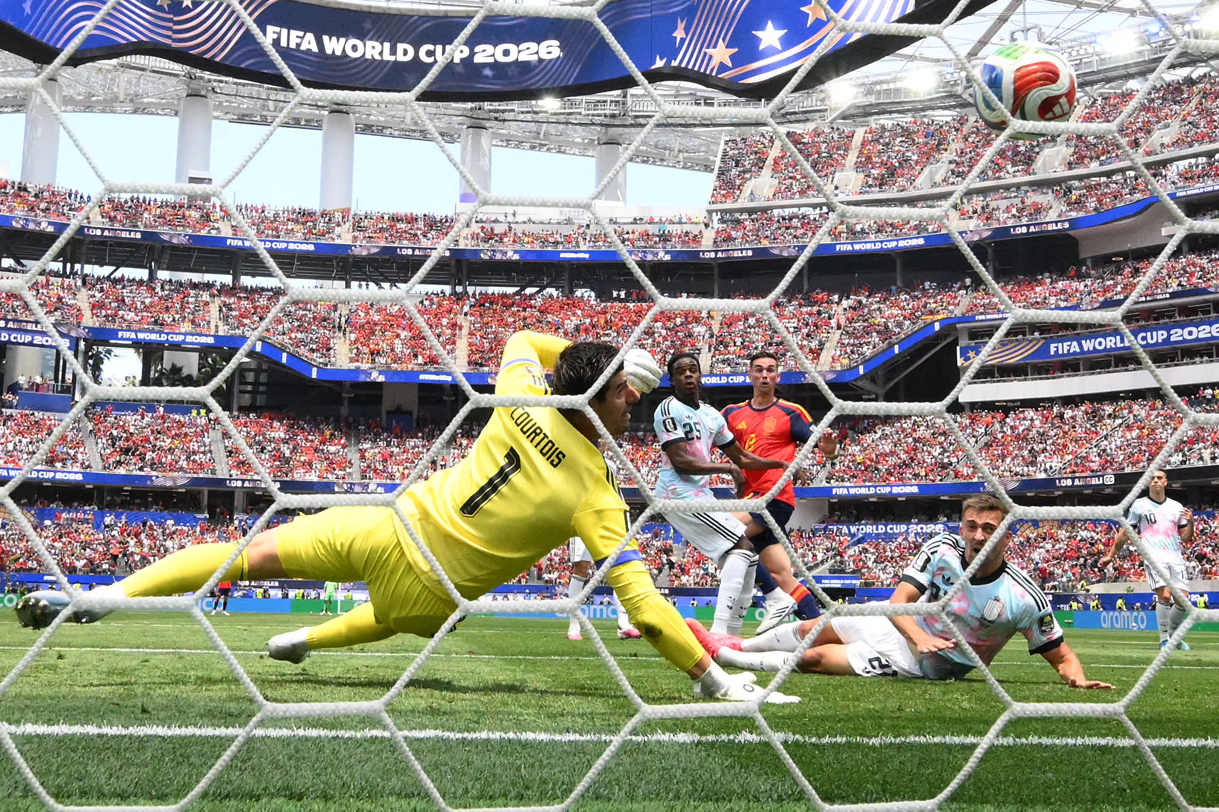 TOPSHOT - Belgium's goalkeeper #01 Thibaut Courtois concedes a goal scored by Spain's midfielder #08 Fabian Ruiz and his team's first goal during the 2026 World Cup football tournament quarter-final match between Spain and Belgium at the Los Angeles Stadium in Inglewood on July 10, 2026. (Photo by Patrick T. Fallon / AFP)