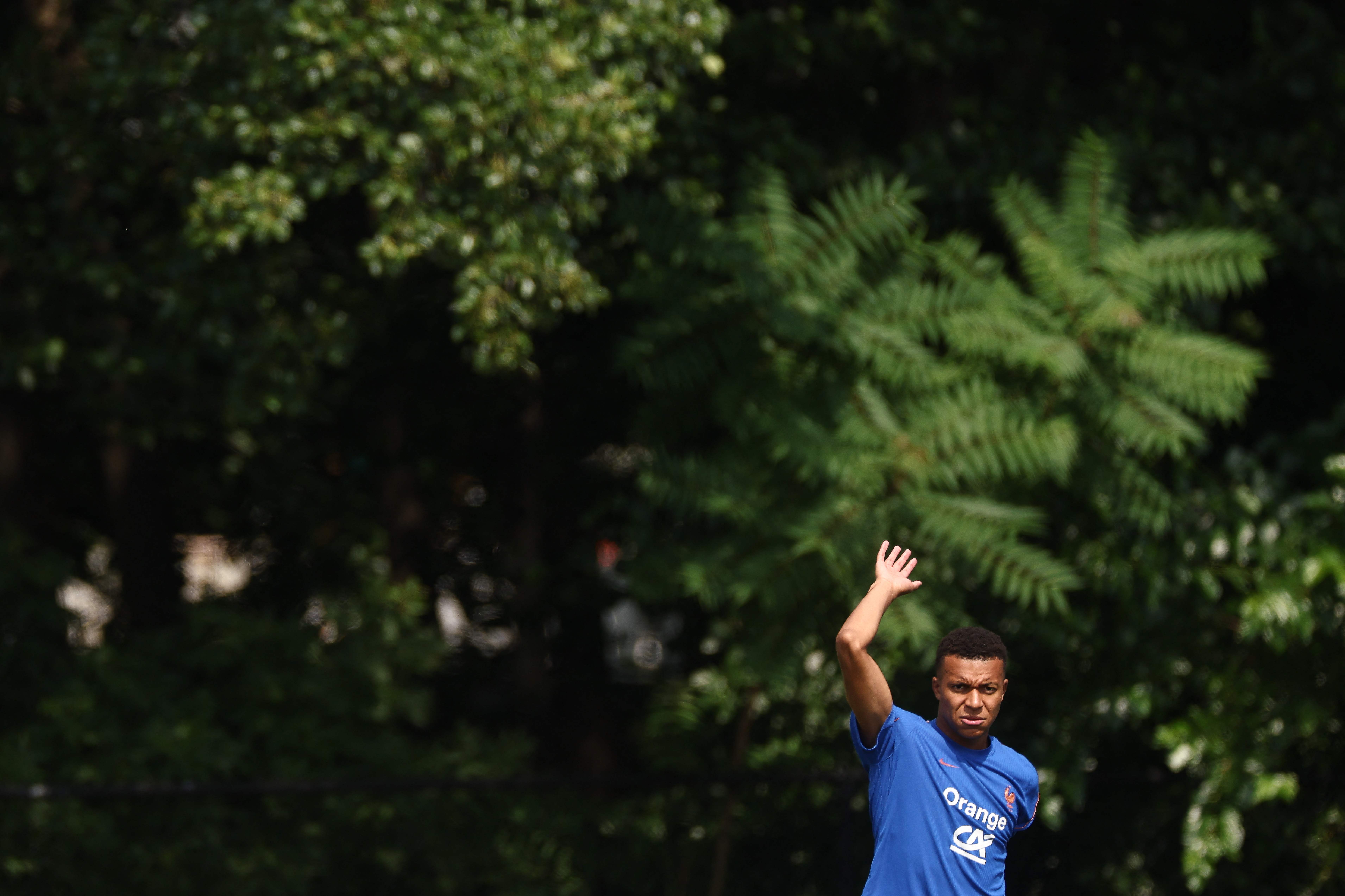 France's forward #10 Kylian Mbappe waves as he arrives for a training session at Bentley University in Waltham, near Boston, on July 11, 2026, during the 2026 World Cup football tournament. (Photo by FRANCK FIFE / AFP)
