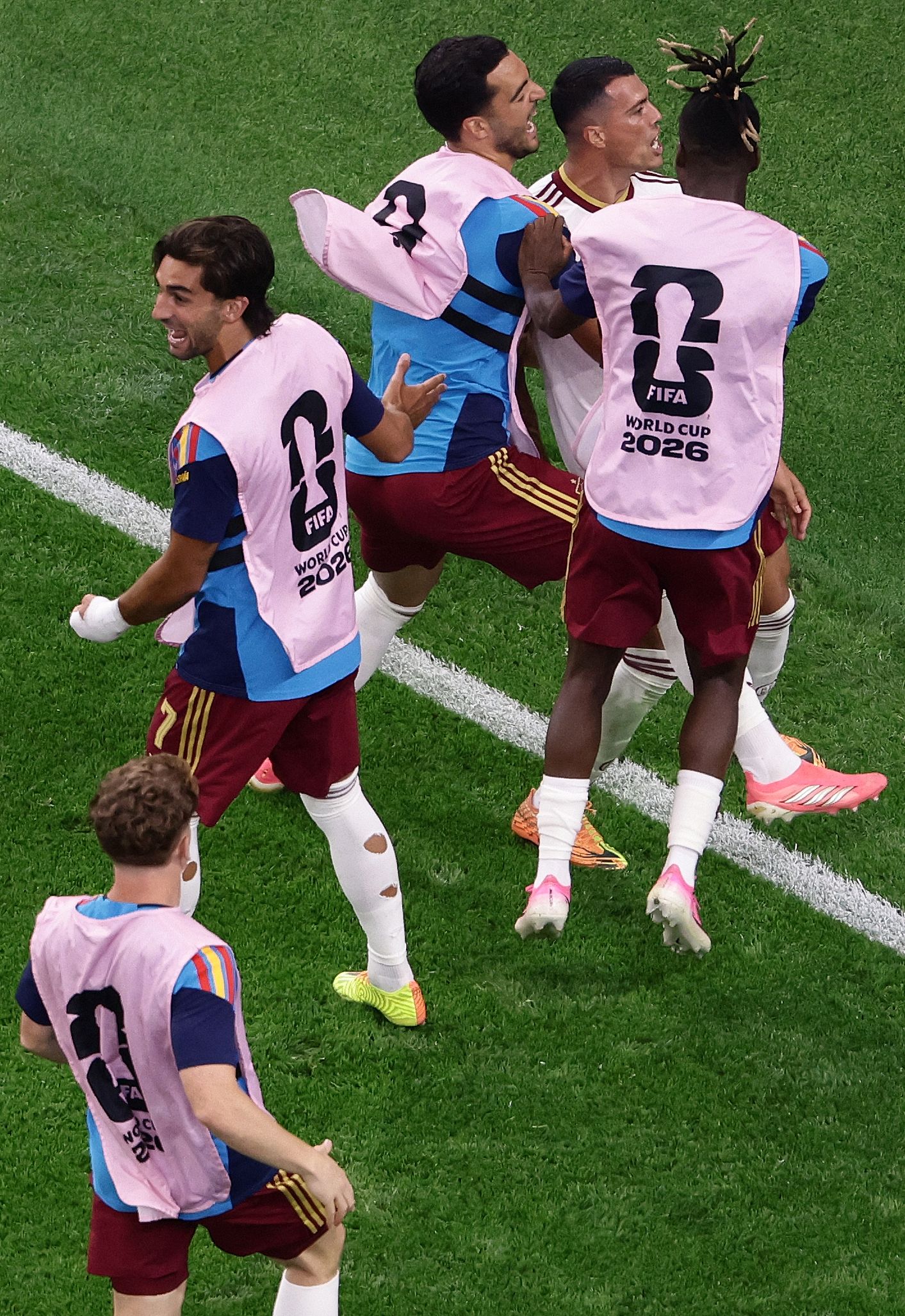 Spain's defender #12 Pedro Porro (2R) is engulfed by teammates as he celebrates after scoring Spain's second goal during the 2026 World Cup football tournament semi-final match between France and Spain at the Dallas Stadium in Arlington on July 14, 2026.  (Photo by Aric Becker / AFP)