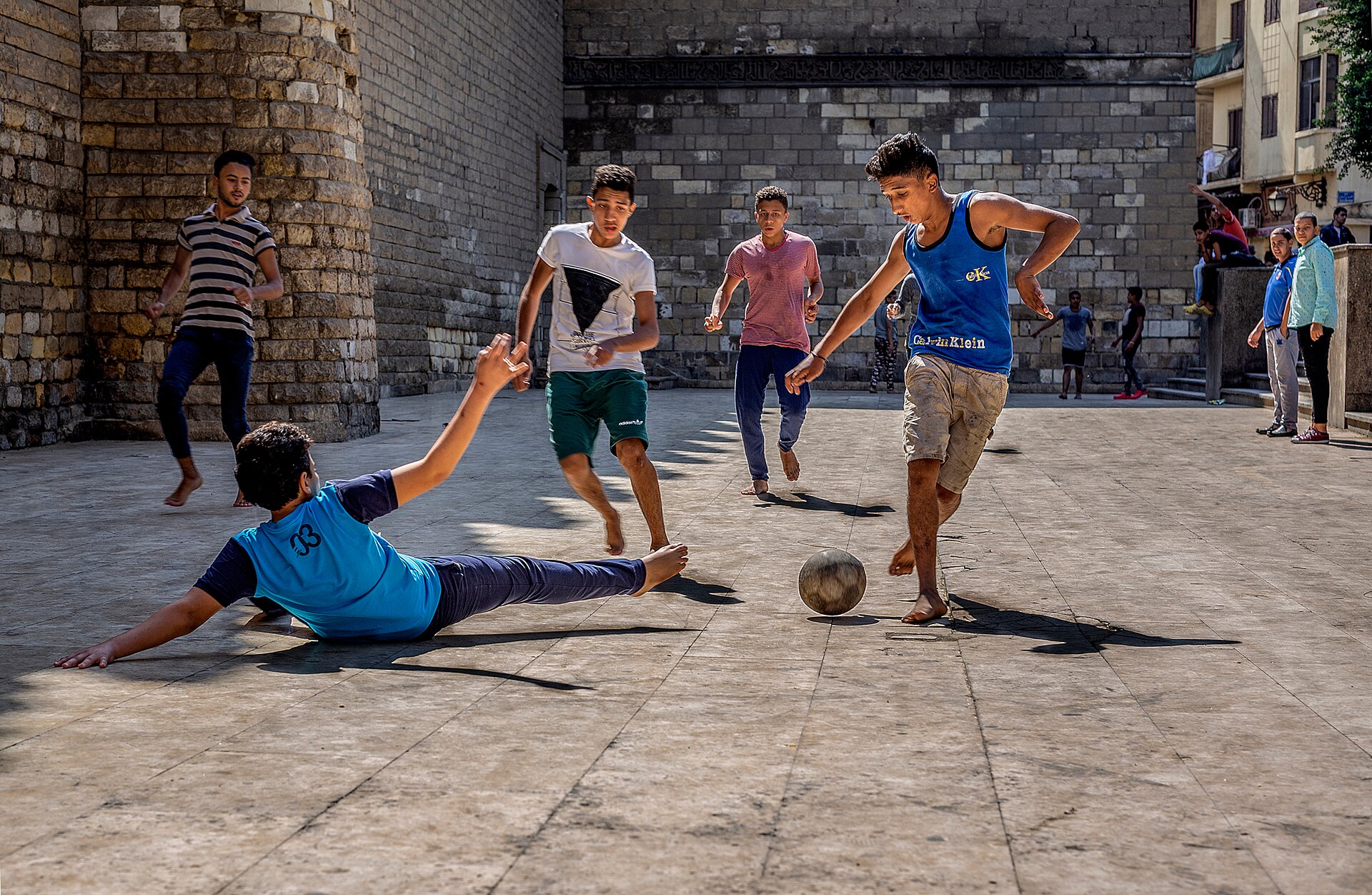 Children playing street football in Egypt, one of the most famous games in Africa. Location: Al-Mu'izz Street, at the exterior of Al-Hakim mosque - Camera location 30° 03′ 17.49″ N, 31° 15′ 47.37″ E View this and other nearby images on: OpenStreetMap 30.054859; 31.263158