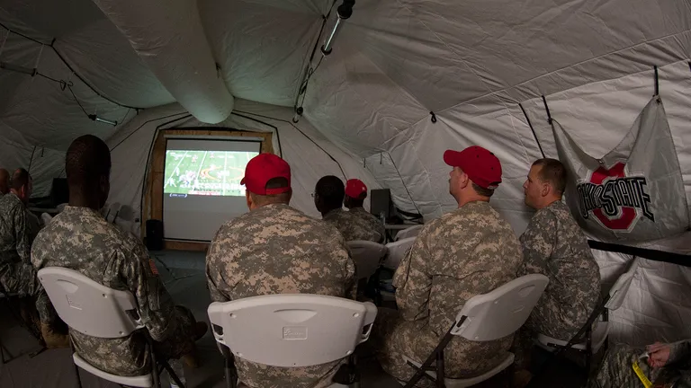 Soldiers deployed in support of Operation United Assistance in Monrovia, Liberia, watch their Ohio State University Buckeyes during the College Football Playoff Championship game, Jan. 13, 2015. The dedicated fans stayed up until 5 a.m. when the game ended. Operation United Assistance is a Department of Defense operation in Liberia to provide logistics, training and engineering support to U.S. Agency for International Development-led efforts to contain the Ebola virus outbreak in western Africa. (U.S. Army photo by Sgt. 1st Class Nathan Hoskins, 101st Airborne Division Public Affairs)