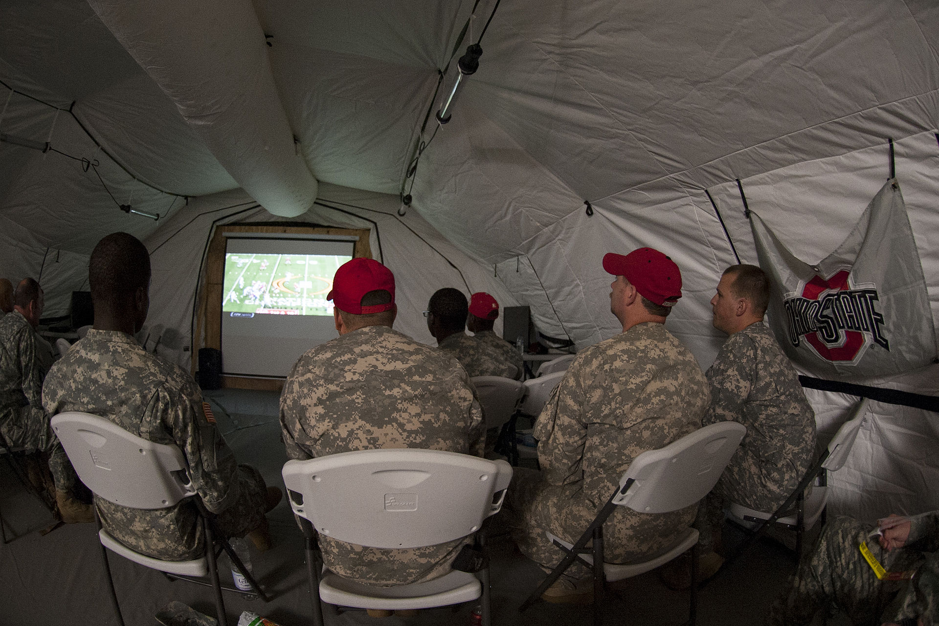 Soldiers deployed in support of Operation United Assistance in Monrovia, Liberia, watch their Ohio State University Buckeyes during the College Football Playoff Championship game, Jan. 13, 2015. The dedicated fans stayed up until 5 a.m. when the game ended. Operation United Assistance is a Department of Defense operation in Liberia to provide logistics, training and engineering support to U.S. Agency for International Development-led efforts to contain the Ebola virus outbreak in western Africa. (U.S. Army photo by Sgt. 1st Class Nathan Hoskins, 101st Airborne Division Public Affairs)