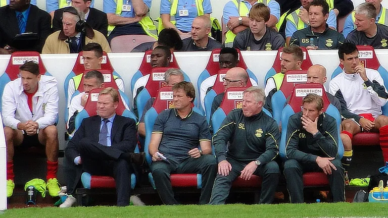Southampton manager Ronald Koeman (front left, in suit and tie) on the bench for Southampton v West Ham at the Boleyn Ground, August 2014.