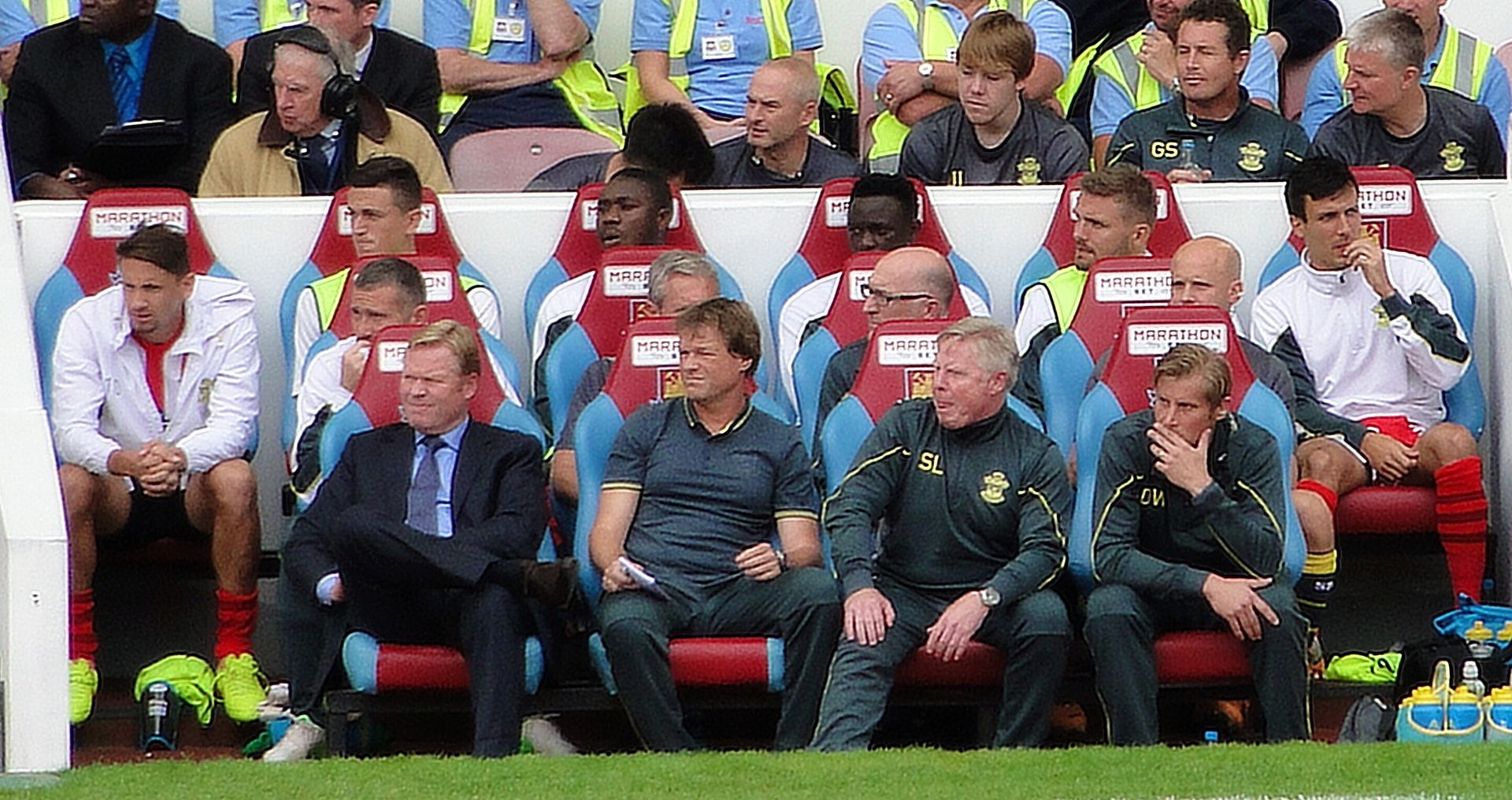 Southampton manager Ronald Koeman (front left, in suit and tie) on the bench for Southampton v West Ham at the Boleyn Ground, August 2014.